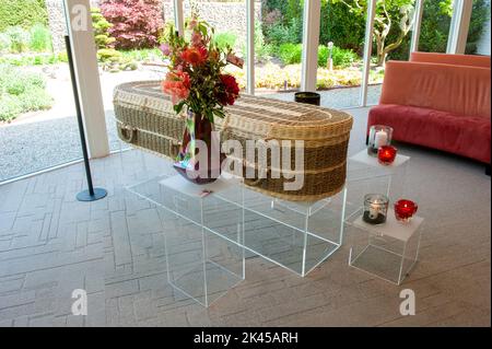A wicker coffin in a funeral home Stock Photo