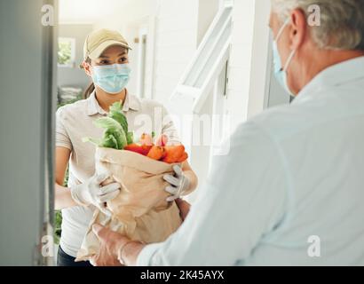 Food delivery, virus and old man in face mask during covid collecting grocery and healthy vegetables at home. Pandemic volunteer giving elderly person Stock Photo