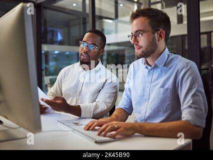 Marketing team at night, working on digital advertising project with teamwork and collaboration in the office on computer. A smart strategy, planning Stock Photo