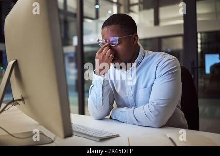 Headache stress, work burnout and businessman working on corporate strategy on the internet in a dark office at night. Corporate employee doing Stock Photo