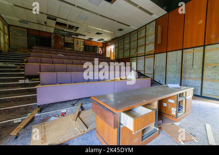 Derelict abandoned lecture theatre in an old college university training department. Stock Photo