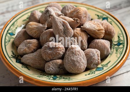 Dish with sweet dried small spanish figs close up Stock Photo