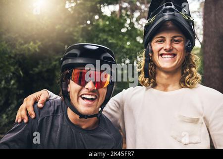 Friends taking a selfie together after cycling through nature trail in the forest. Portrait of cyclist men from Sweden or Norway smiling wearing Stock Photo