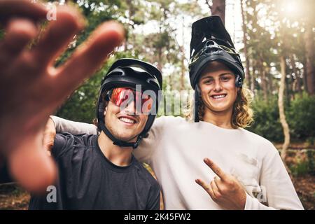 Forest, cycling and friends take a selfie in nature on an outdoor bicycle adventure in the woods in summer. Sports, bikers and happy men in a picture Stock Photo