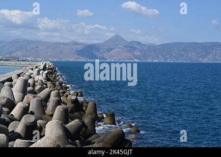 Concrete tetrapod breakwater stones piled up in wave breaker to protect Port of Heraklion, Stock Photo