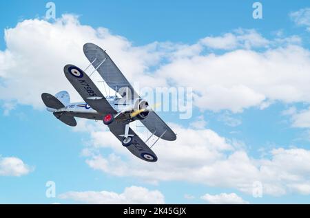 WW2 plane - A Gloster Gladiator Mk 1 biplane, used in world war 2 as a fighter plane, flying at the Imperial War Museum Duxford UK Stock Photo