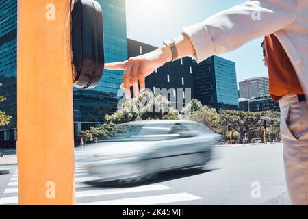 Woman hand pressing a traffic light button at a pedestrian crossing on the urban city street. Outdoor crosswalk, road and business employee walking Stock Photo