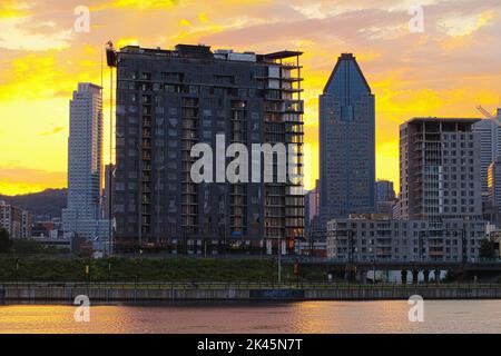 The Quebec city skyline and construction, downtown view from across the St Lawrence River at dawn. Stock Photo