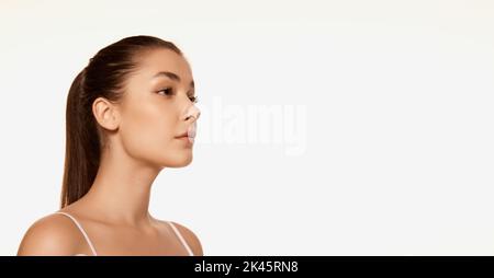 Portrait of young beautiful woman with clear spotless skin isolated over white background. Cosmetology treatment. Flyer Stock Photo