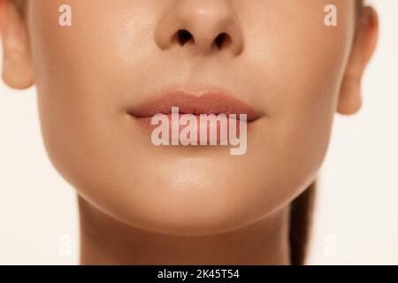 Portrait of young beautiful woman with clear spotless skin isolated over white background Stock Photo