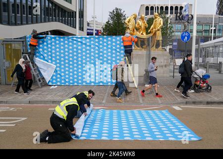 Workers cover perimeter fencing in Conservative Party signage in Birmingham ahead of the Conservative Party annual conference, which takes place at the International Convention Centre in the city next week. Picture date: Friday September 30, 2022. Stock Photo