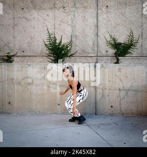 Sequence of Shots of Happy Young Black Woman Jumping Off a Walkway Stock Photo