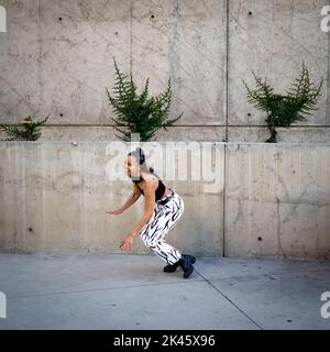 Sequence of Shots of Happy Young Black Woman Jumping Off a Walkway Stock Photo