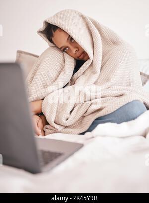 Laptop, mental health problem and insomnia woman from Rome feeling sad on a bed with depression. Depressed person with a computer in a house bedroom Stock Photo