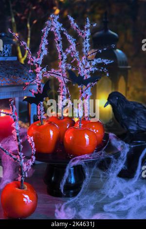 Halloween dessert. Poisoned blood caramelized glazed candy apple. Snow White Poison Lollipops. Stock Photo
