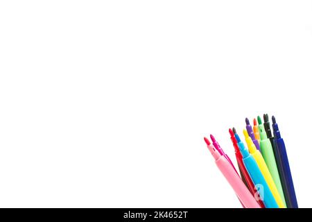 Open colored markers on the corner of a white background with copy space Stock Photo