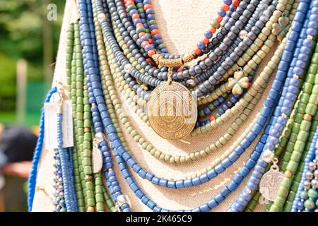 Traditional Ukrainian ethnic style jewelry made with ceramic beads. Exclusive handmade necklaces at souvenir stall or street Sunday market. Selective Stock Photo