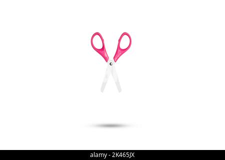 Metal scissors with pink platsic handle floating on a white background with copy space Stock Photo
