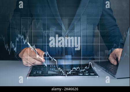 Business management using modern digital technologies. Man using tablet analyzing sales data and economic growth graph chart. digital transformation Stock Photo