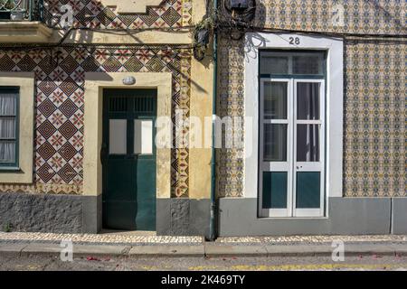 Aveiro, Portugal - August 14, 2022: View of two adjacent residences showing entrance doors and ornate tiling surrounds Stock Photo