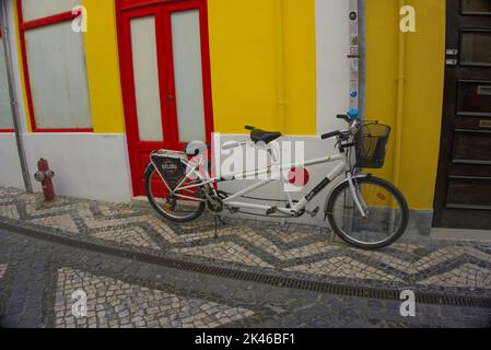 Aveiro, Portugal - August 14, 2022: Tandem hire bicycle parked in street Stock Photo