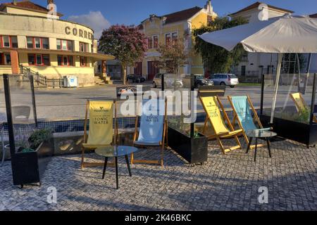 Aveiro, Portugal - August 14, 2022: Unoccupied deck chairs at bar with Fever Tree Tonic Water inscribed on back Stock Photo