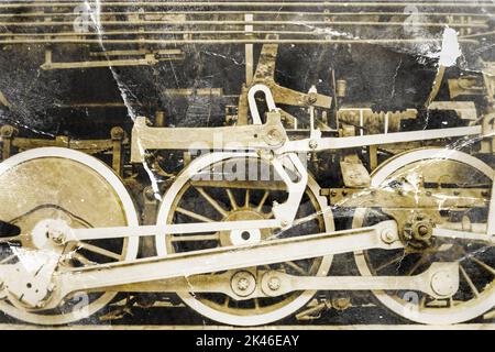 Old steam locomotive steel wheels and mechanics closeup, stylized as an crumpled old photo Stock Photo