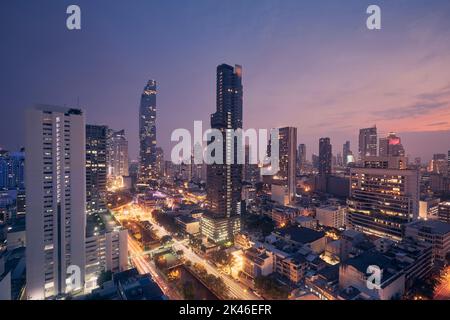 Night view of Bangkok skyline and illuminated high-rise buildings along ...