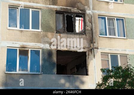 Windows of burnt-out apartments in a apartment building. Consequences of the fire Stock Photo