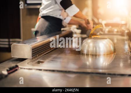 Hand of man take cooking of meat with vegetable grill, Chef cooking wagyu beef in Japanese teppanyaki restaurant Stock Photo