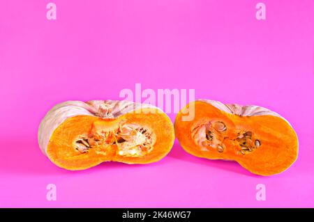 Organic pumpkin cut in half. Food for the fall. Halloween. Stock Photo