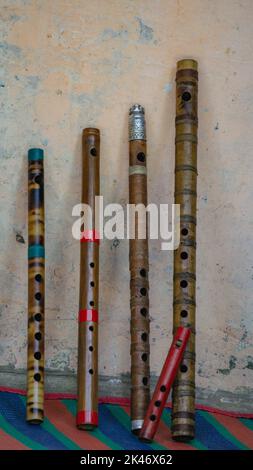 Flute of Bangladesh. Handmade bamboo flute. The flutes are arranged in rows. Stock Photo