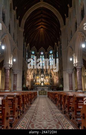 Cobh, Ireland - 15 August, 2022: vertical view of the central nave and altar inside the Cobh Cathedral Stock Photo