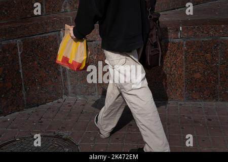 A customer seen carrying a McDonald's paper bag on the street. Fast food chain McDonald’s has reopened 10 restaurants in Kyiv, resuming their dine-in service, first time after they closed all their restaurants in March. The fast food chain made a surprise announcement on their facebook account but warning there could be potential long queues. The chain has already reopened a handful of their restaurants 10 days ago but limited to takeaway service. Stock Photo