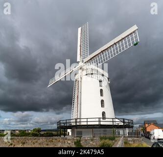 Blennerville, Ireland - 5 August, 2022: view of the historic Blennerville Windmill in Tralee Bay in western Ireland under stormy skies Stock Photo