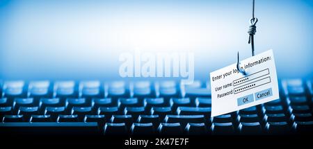 Login Information Attached To Large Hook Hanging In Front Of Computer - Cyber Crime / Phishing Concept Stock Photo