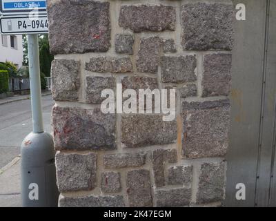 Wall made from blocks of stone and mortar or concrete between the blocks. Wall constructed to give protection. Example of stone texture. Stock Photo