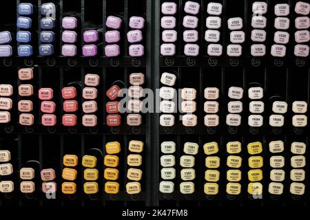 Front view of multicolored felt tip pens placed on rack in art and crafts store, vertical art background Stock Photo