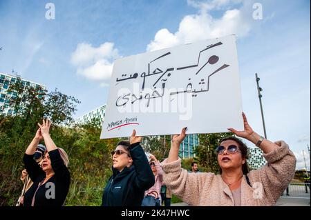 Iranian women are seen holding a big banner with a song about freedom
