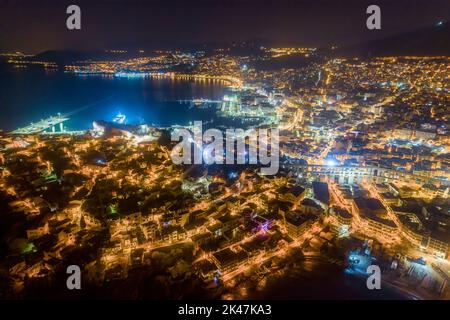 Aerial view the city of Kavala at night, in northern Greece, ancient aqueduct Kamares, homes and medieval city wall Stock Photo