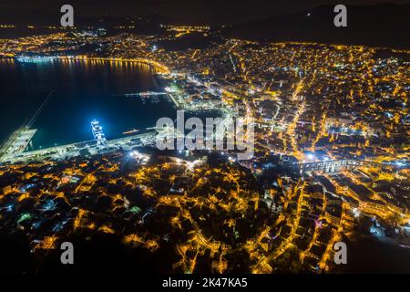 Aerial view the city of Kavala at night, in northern Greece, ancient aqueduct Kamares, homes and medieval city wall Stock Photo