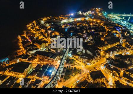 Aerial view the city of Kavala at night, in northern Greece, ancient aqueduct Kamares, homes and medieval city wall Stock Photo