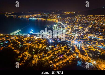 Aerial view the city of Kavala at night, in northern Greece, ancient aqueduct Kamares, homes and medieval city wall Stock Photo