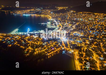 Aerial view the city of Kavala at night, in northern Greece, ancient aqueduct Kamares, homes and medieval city wall Stock Photo