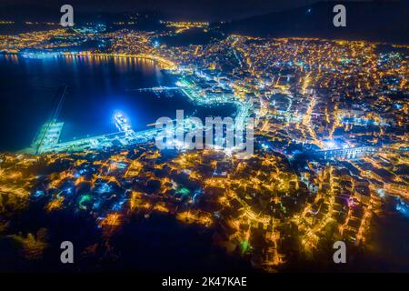 Aerial view the city of Kavala at night, in northern Greece, ancient aqueduct Kamares, homes and medieval city wall Stock Photo