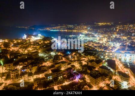 Aerial view the city of Kavala at night, in northern Greece, ancient aqueduct Kamares, homes and medieval city wall Stock Photo