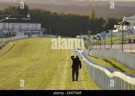 29th September, 2022  Epsom Downs, Surrey, UK  A Local man walks down the finishing straight of the famous Epsom Downs racecourse (home of The Derby) where locals exercise on the Downs above Epsom -  the local Surrey town Stock Photo