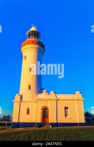 Norah lighthouse on Central coast of Australia at sunrise against clear blue sky. Stock Photo