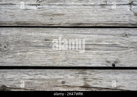 Wood barn planks background, old rustic wooden wall close-up. Weathered rough timber with cracks, grain and knots, gray vintage dry boards for wallpap Stock Photo