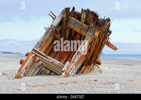 The remaining hull of the Pesuta shipwreck lying in sand north of Tlell River on East Beach in the Naikoon Provincial Park, Haida Gwaii, BC, Canada Stock Photo